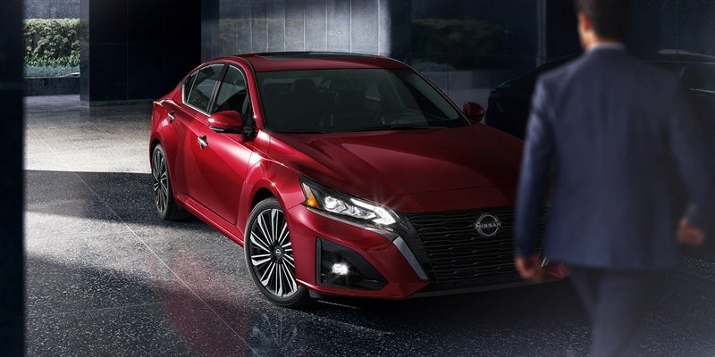 A man walking up to his parked 2024 Nissan Altima in Pompano Beach, FL