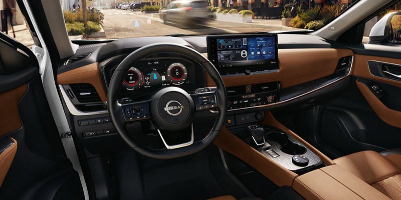 The dashboard and infotainment system of the 2024 Nissan Rogue in Pompano Beach, FL